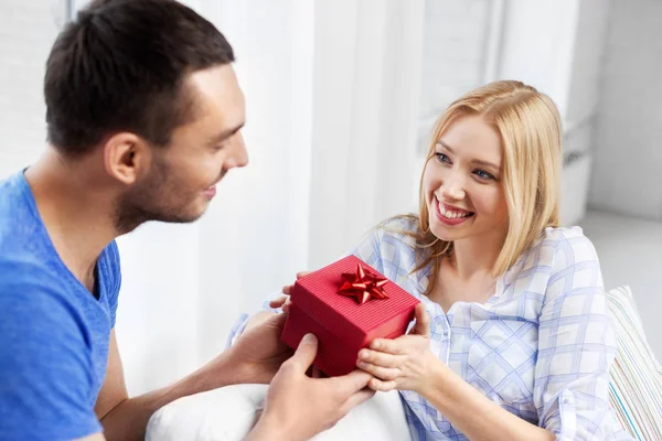 Happy couple with gift box at home Stock Photo