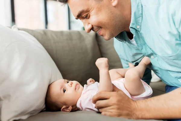 Middle aged father playing with baby at home — Stock Photo, Image