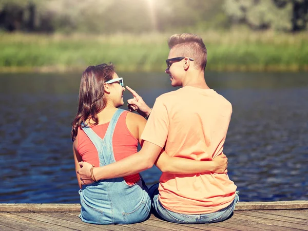 Happy teenage couple hugging on river summer berth — Stock Photo, Image