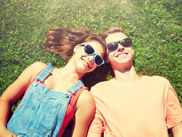 Glückliches Teenie-Paar liegt im Sommer im Gras — Stockfoto