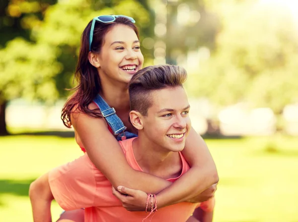 Happy teenage couple having fun at summer park — Stock Photo, Image