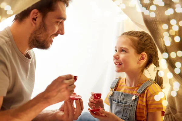 Rodzina gra tea party w namiocie dzieci w domu — Zdjęcie stockowe