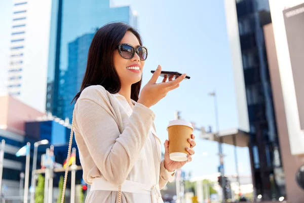 Woman recording voice by smartphone in city — Stock Photo, Image