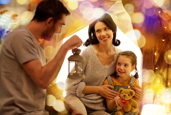 Happy family playing in kids tent at night at home — Stock Photo, Image