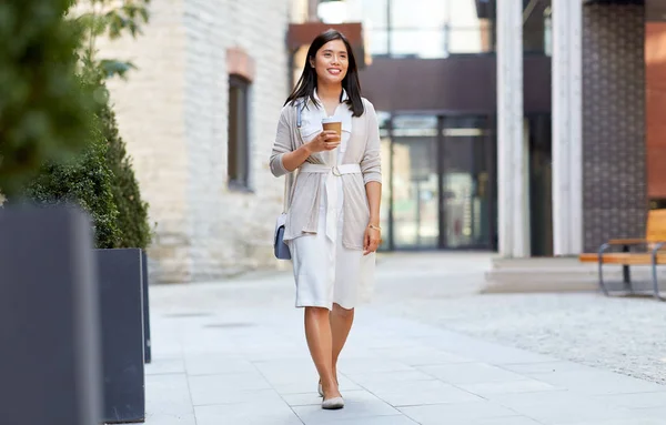 Lachende vrouw met afhaalmaaltijden koffie kopje in stad — Stockfoto