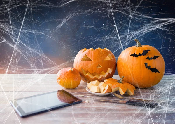 Halloween jack-o-lantern, pompoenen en tablet pc — Stockfoto