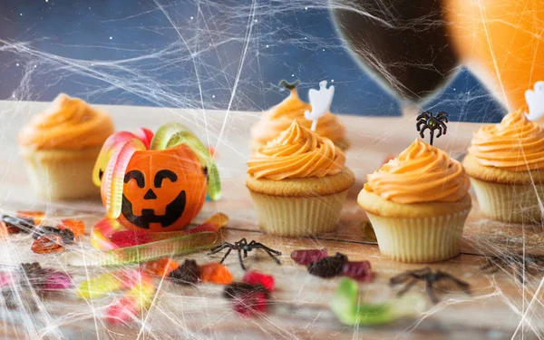 Fiesta de halloween cupcakes y caramelos en la mesa — Foto de Stock