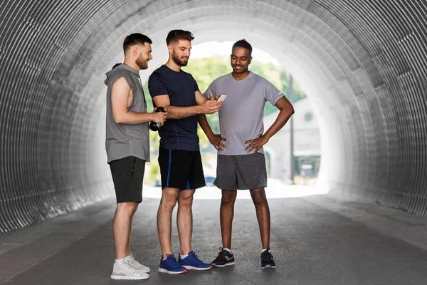 Sporty men or friends with smartphone outdoors — Stock Photo, Image