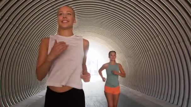 Young women or female friends running outdoors — Stock Video