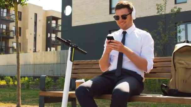 Geschäftsmann mit Handy, Kopfhörer und Kaffee — Stockvideo