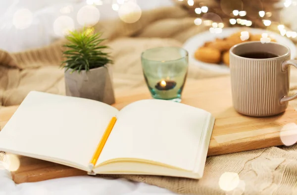 Diary, tea and candle in holder at home — Stock Photo, Image