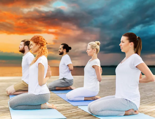 People making yoga in hero pose outdoors — Stock Photo, Image