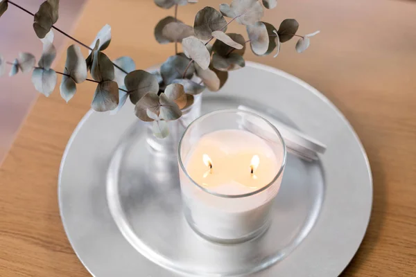 Burning white candles on table at cozy home — Stock Photo, Image