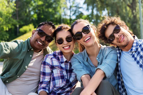 Amigos felices tomando selfie en el parque de verano —  Fotos de Stock