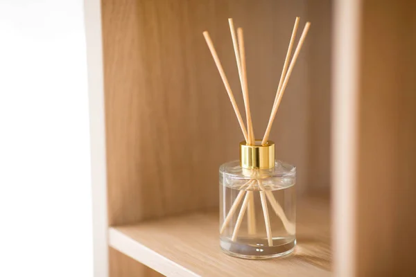 Aroma reed diffuser on wooden shelf — Stock Photo, Image