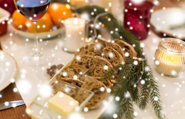 Bread slices and other food on christmas table — Stock Photo, Image