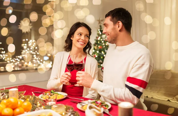 Happy couple drinking red wine at christmas dinner — Stock Photo, Image