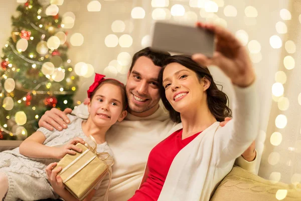 Happy family with christmas present at home — Stock Photo, Image