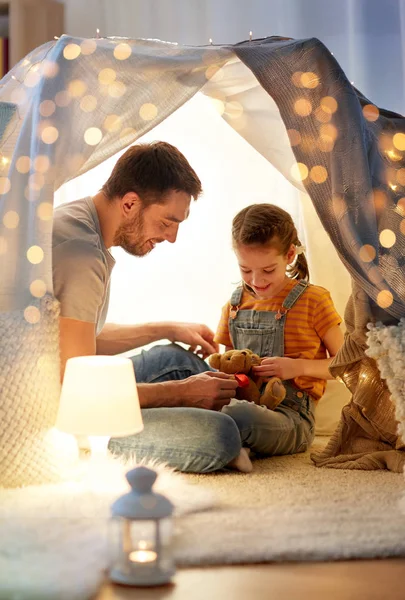 Happy family playing with toy in kids tent at home — Stock Photo, Image