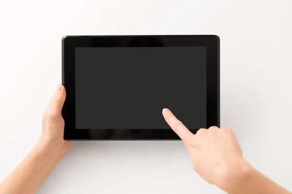 Закрыть руки черным планшетным компьютером — стоковое фото