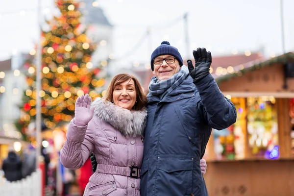 Senior couple agitant les mains au marché de Noël — Photo