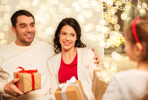 Happy family giving christmas presents at home Stock Picture