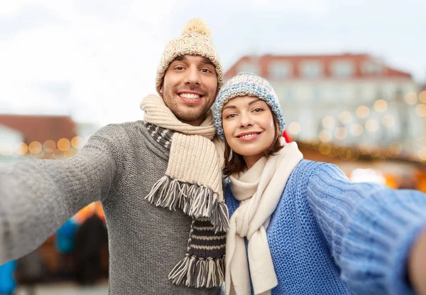 Casal feliz tomando selfie no mercado de natal — Fotografia de Stock