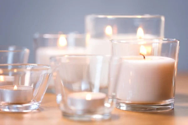 Burning white fragrance candles on wooden table — Stock Photo, Image