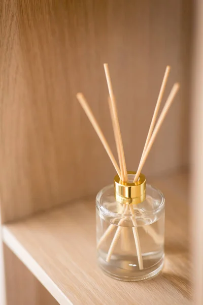 Aroma reed diffuser on wooden shelf — Stock Photo, Image