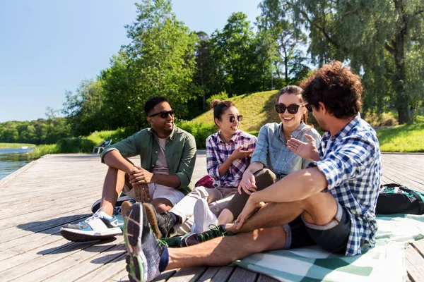 Friends hanging out and talking outdoors in summer Royalty Free Stock Images