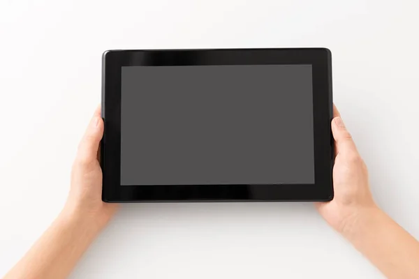 Close up of hands with black tablet computer — Stock Photo, Image
