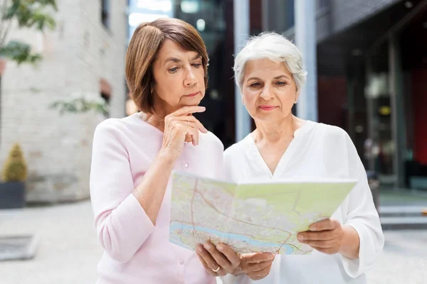 Senior women con mapa de la ciudad en la calle en tallinn —  Fotos de Stock