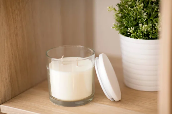 Fragrance candle in glass holder on shelving — Stock Photo, Image