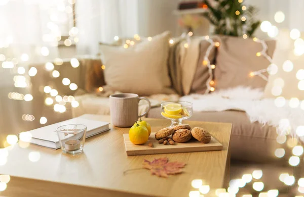 Oat cookies, book, tea and lemon on table at home — Stock Photo, Image