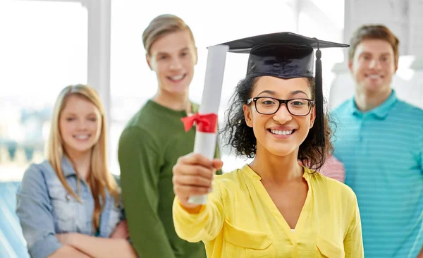 Graduate student girl in mortar board with diploma — Stock Photo, Image