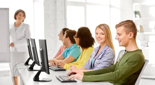 Happy high school students in computer class — Stock Photo, Image