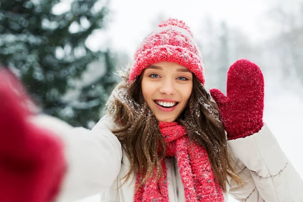 Uśmiechnięta kobieta biorąc selfie na zewnątrz zimą — Zdjęcie stockowe