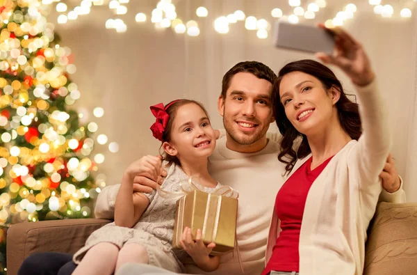 Happy family with christmas present at home — Stock Photo, Image