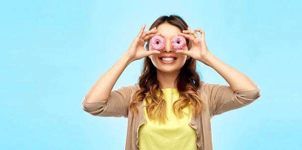 Happy asian woman with eyes of donuts — Stock Photo, Image