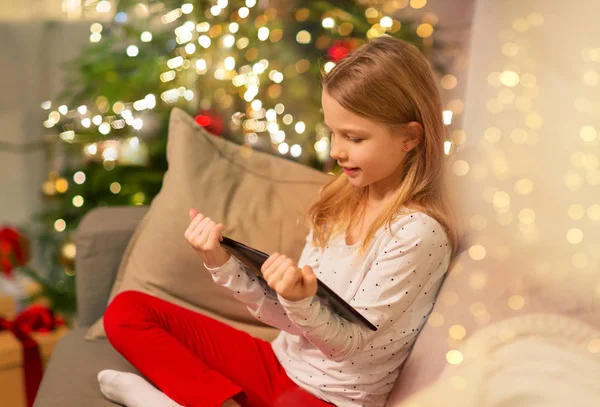 Chica sonriente con la tableta de la PC en casa de Navidad —  Fotos de Stock