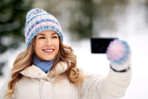 Mujer tomando selfie por teléfono inteligente en invierno — Foto de Stock