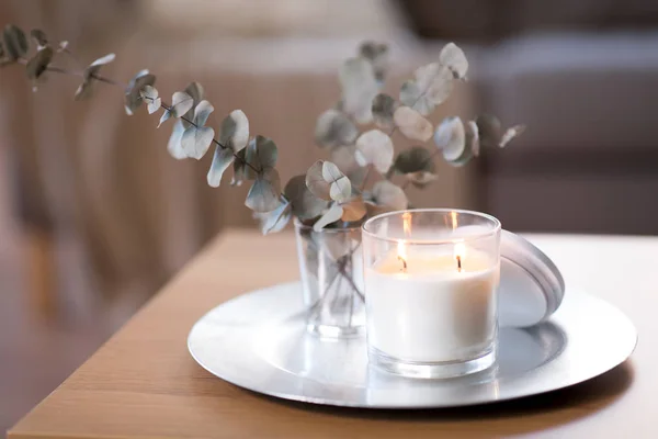 Burning fragrance candle on table at cozy home — Stock Photo, Image