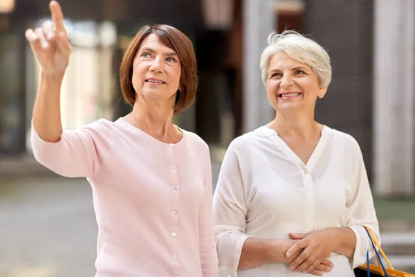 senior women with shopping bags in tallinn city