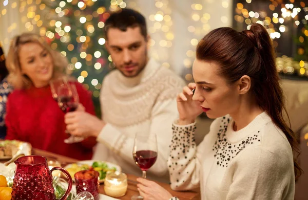 Woman calling on smartphone at christmas dinner — Stock Photo, Image