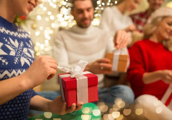 Close up of friends opening christmas gifts — Stock Photo, Image