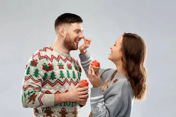 Pareja con cupcakes en suéteres feos de Navidad — Foto de Stock