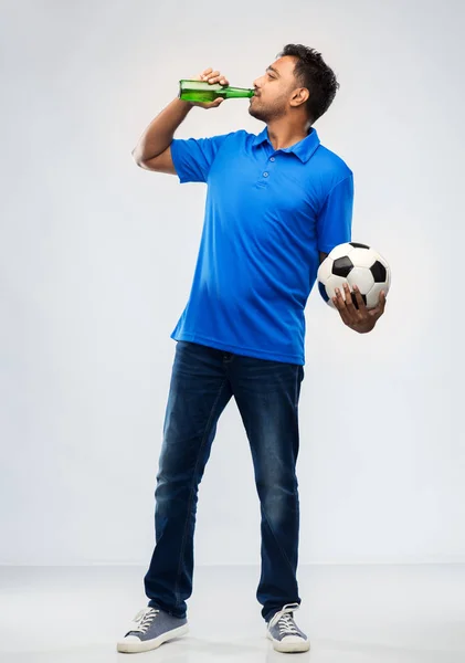 Índio fã de futebol masculino com bola de futebol e cerveja — Fotografia de Stock