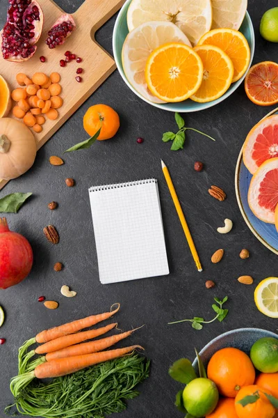 Close up of notebook, fruits and vegetables — Stock Photo, Image
