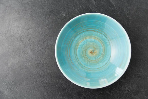 Primo piano di piatto di ceramica blu su sfondo ardesia — Foto Stock