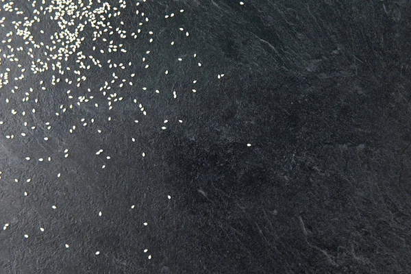 Sesame seeds on slate stone background — Stock Photo, Image